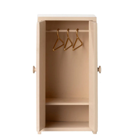 Beige wardrobe with gold hooks on a white background