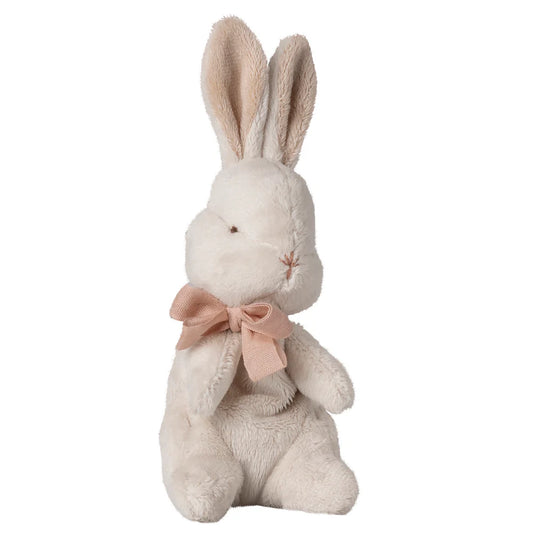Plush rabbit toy with a pink bow on a white background