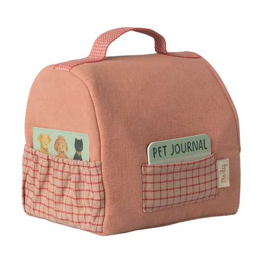 Pink pet journal with checkered pockets on a white background