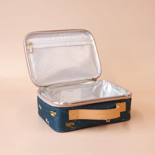 Insulated lunch bag with a gold zipper on a beige background