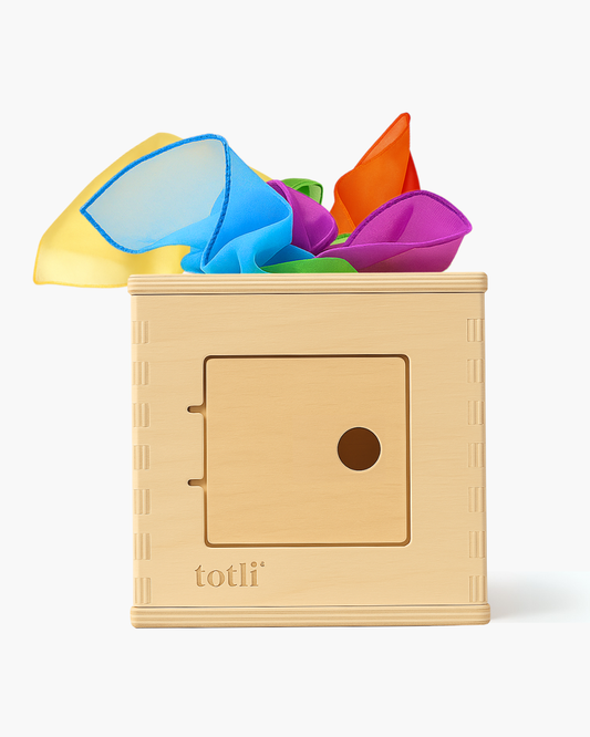 Colorful geometric shapes in a wooden box with 'totli' branding on a white background