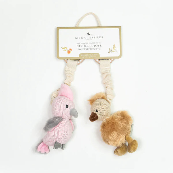Two knitted bird toys on a rope with a Living Textiles tag on a white background
