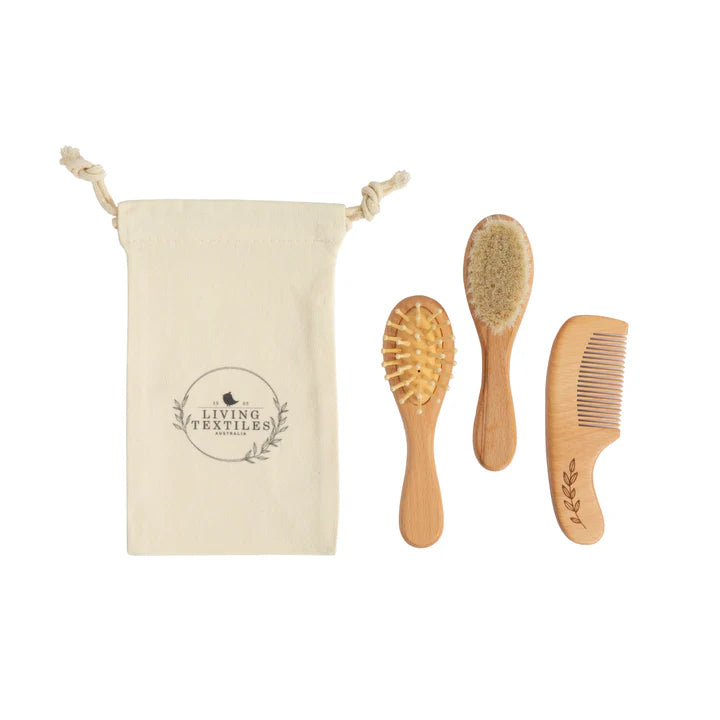 Set of wooden hairbrushes and comb with a pouch on a white background