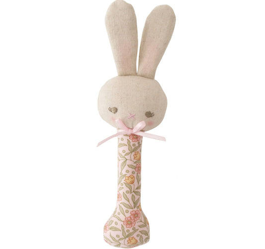 Stuffed bunny toy with floral patterned handle on a white background