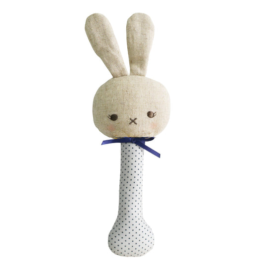 Textured bunny rattle with a polka dot handle on a white background