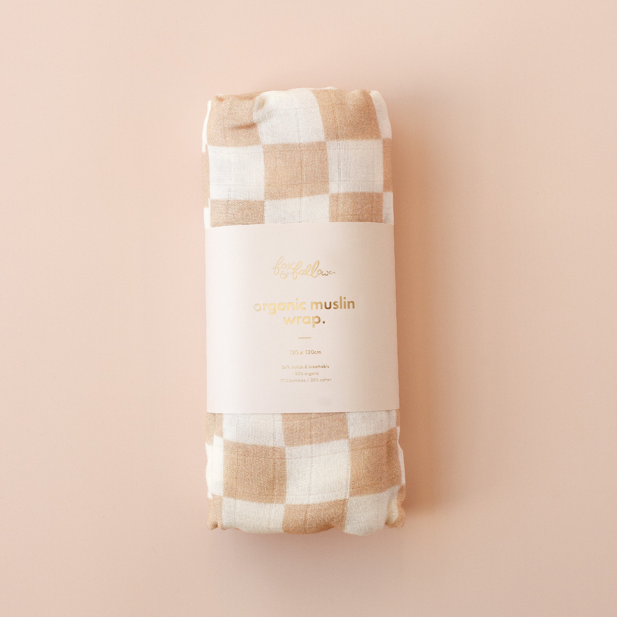 Checkered muslin wrap with 'organic muslin wrap' text on a beige background