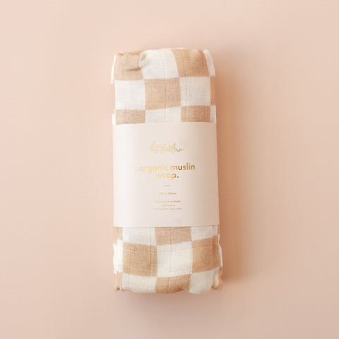 Checkered muslin wrap with 'organic muslin wrap' text on a beige background