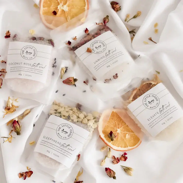 Various bath products with visible branding on a white background