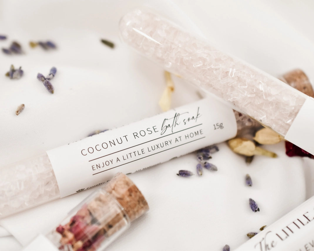 Coconut Rose bath soap with lavender and rose petals on a white surface