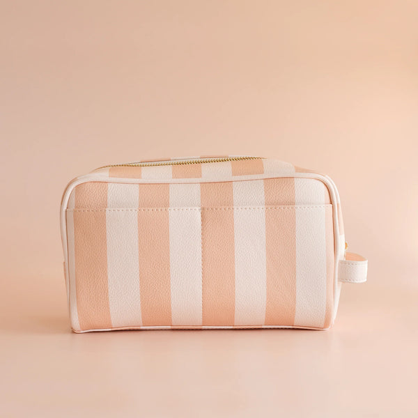 Rectangular striped washbag with a zipper on a beige background