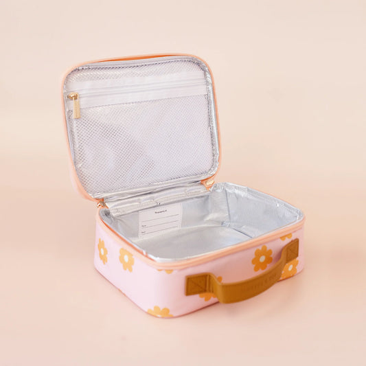Pink lunch bag with floral design on a beige background