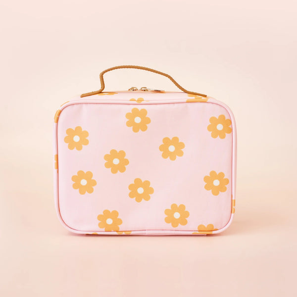 Pink lunch bag with yellow floral pattern on a beige background