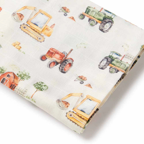 Fabric with colorful tractor and truck patterns on a light background