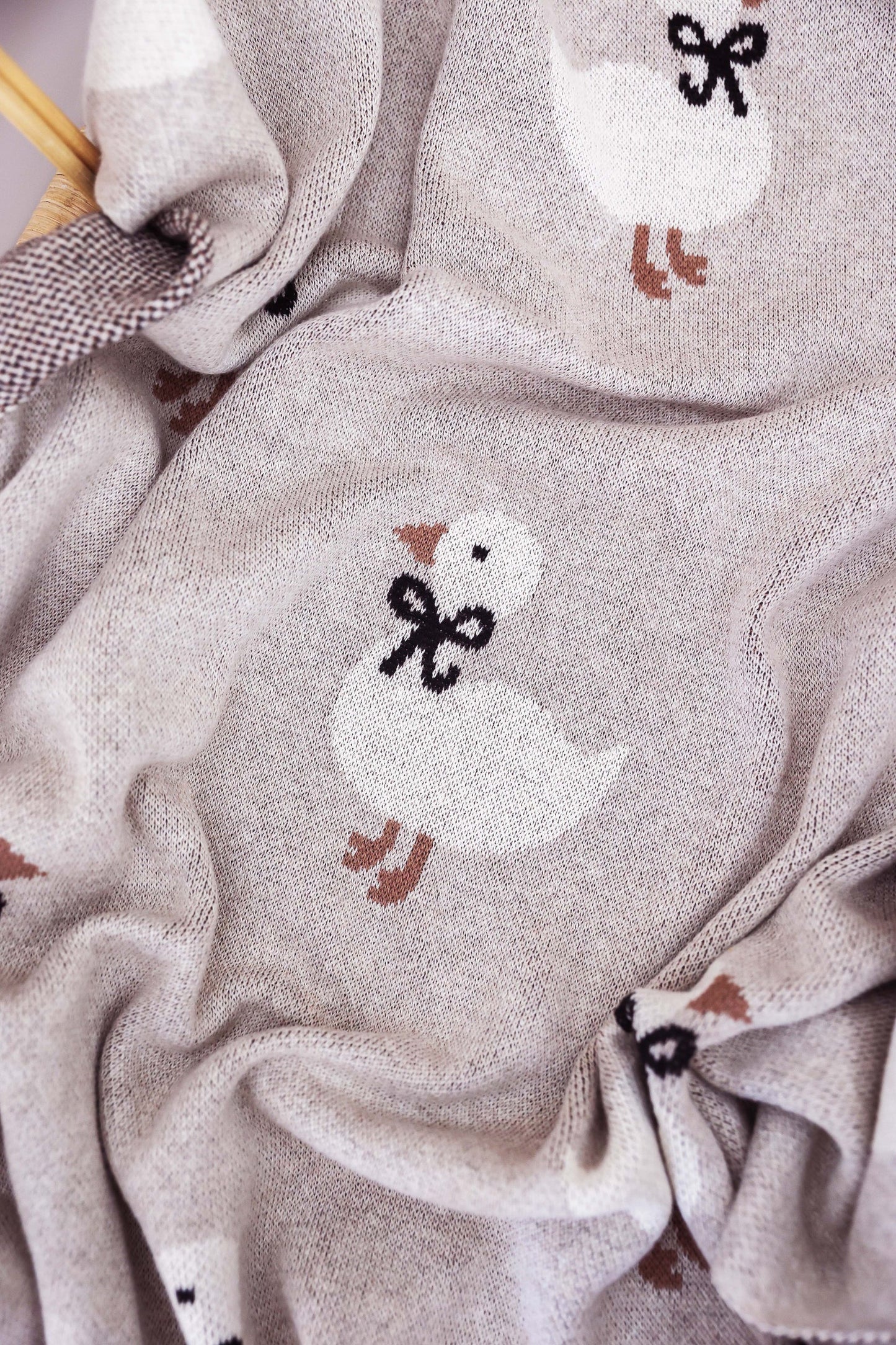 Close-up of fabric with knitted duck designs on a textured background