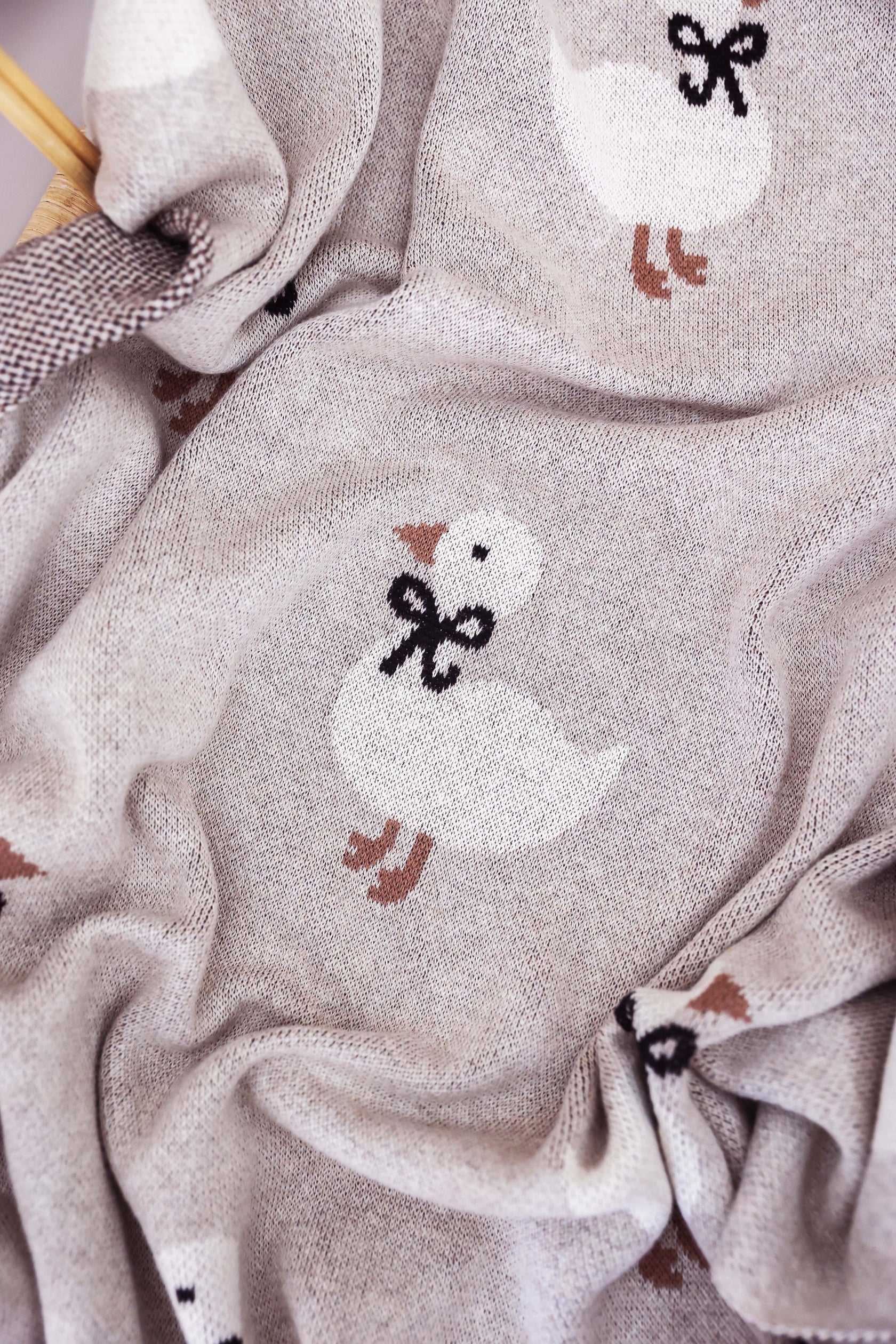 Close-up of fabric with knitted duck designs on a textured background