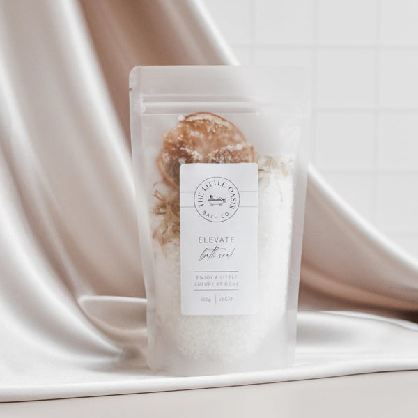 Bath salt package with decorative elements on a satin background