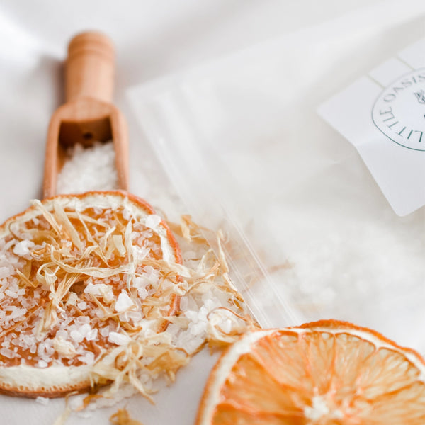 Dried orange slices with sea salt on a white surface