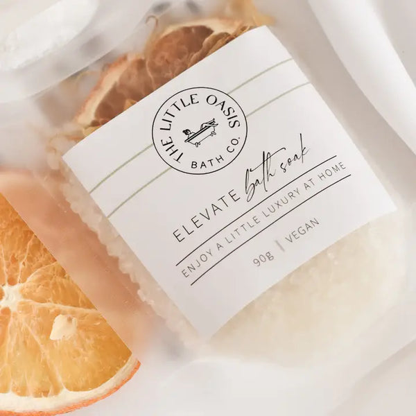 Bath Soak with 'The Little Oasis Bath Co.' label surrounded by orange slices.