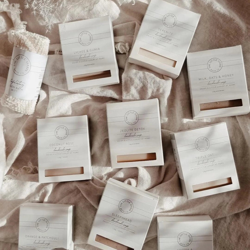Collection of soap packages on a textured fabric background