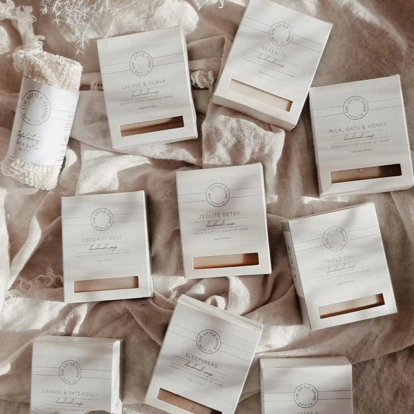 Collection of soap packages on a textured fabric background