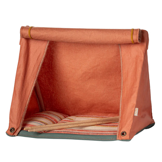 Orange pet tent with striped bedding on a white background