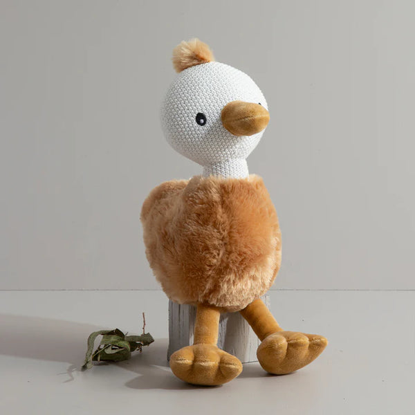 Plush toy duck with white head and brown body on a light gray background