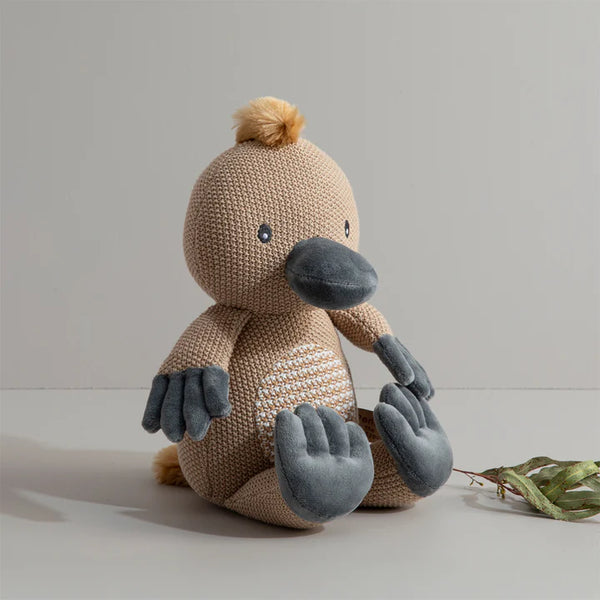 Knitted toy resembling a beaver on a plain background
