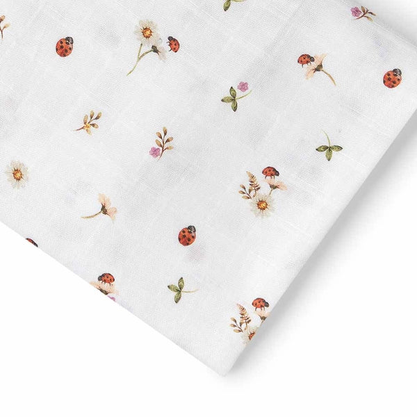 White fabric with small floral and ladybug patterns