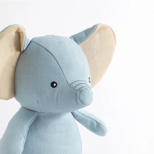 Blue elephant plush toy with beige ears on a white background