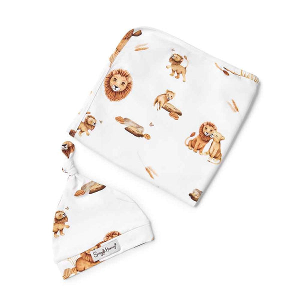 Baby hat and blanket set with lion print on a white background