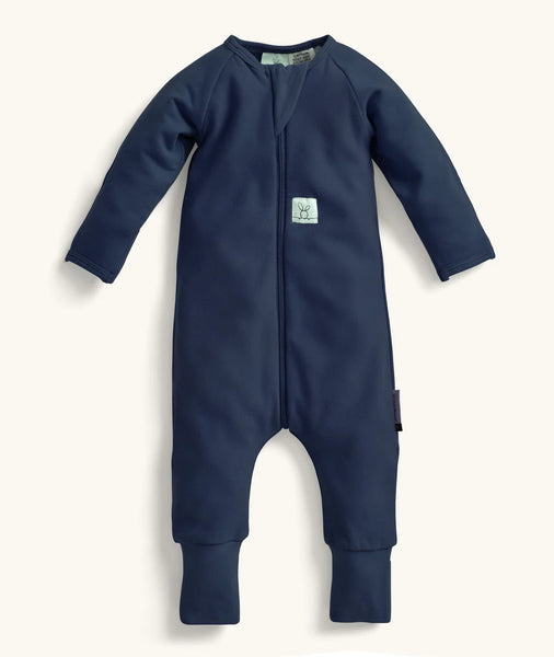 Navy blue baby onesie with a small white label on a white background