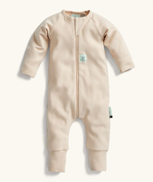 Beige baby onesie with a zipper on a white background