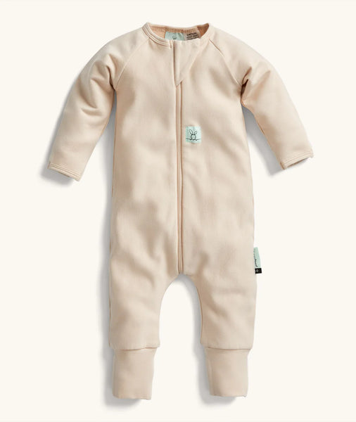 Beige baby onesie with a zipper on a white background