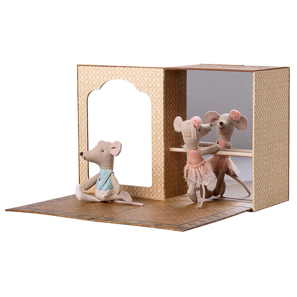 Three toy mice in a decorative box on a white background