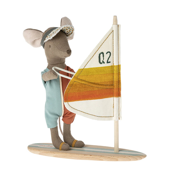 Small figurine of a mouse with a sailboat on a white background