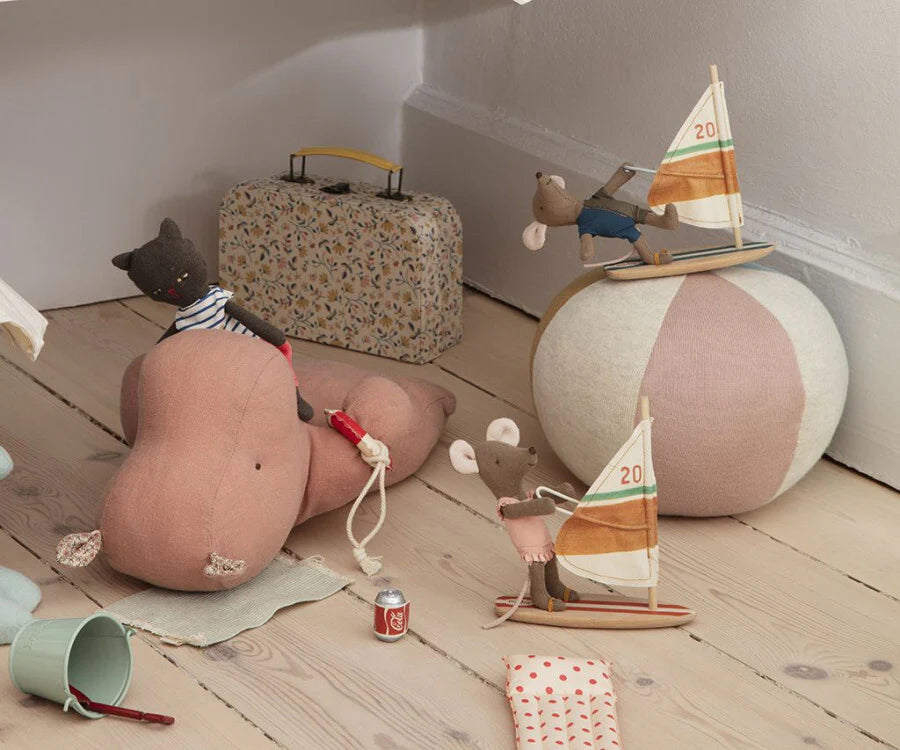 Maileg toys including a teddy bear, Surfer Big Brother Mouse, and suitcase on a wooden floor.