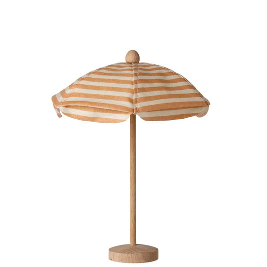 Small striped umbrella with a wooden base on a white background