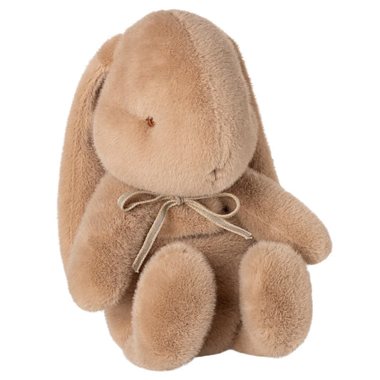 Brown plush bunny toy with a bow on a white background