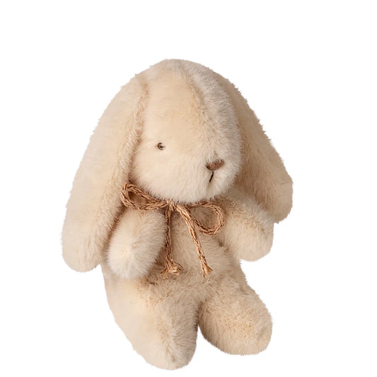 Beige plush bunny with a brown bow on a white background