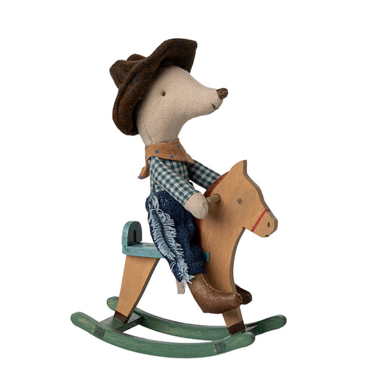 Toy mouse in cowboy outfit riding a rocking horse on a white background