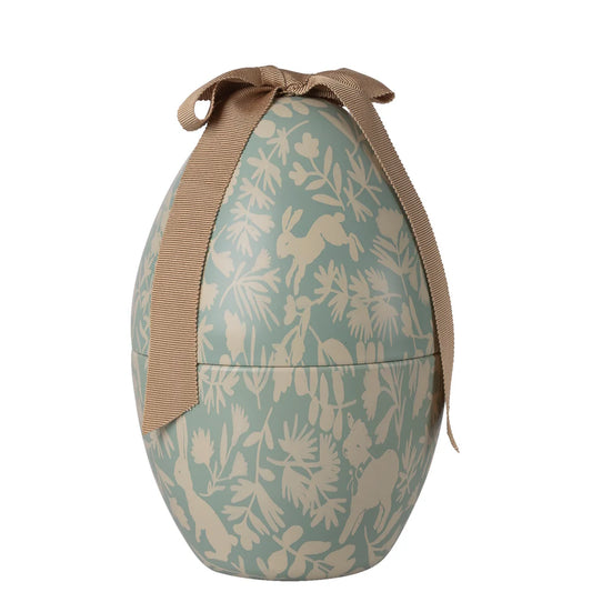 Decorative egg-shaped container with rabbit and floral pattern and brown ribbon on a white background