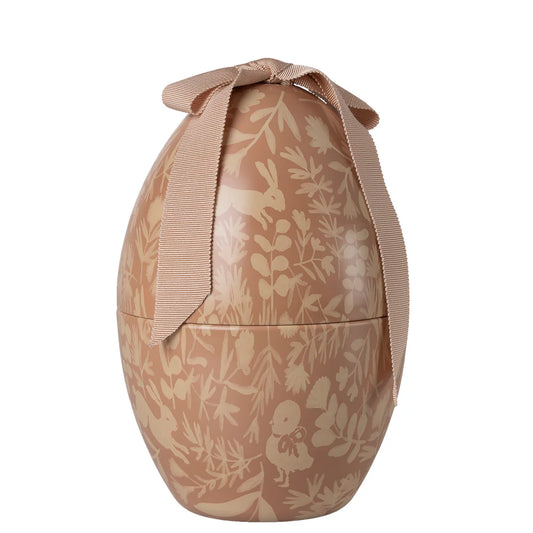 Decorative egg with floral and animal pattern and a ribbon on a white background