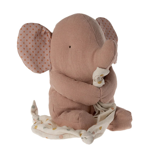 Stuffed elephant toy with a blanket on a white background