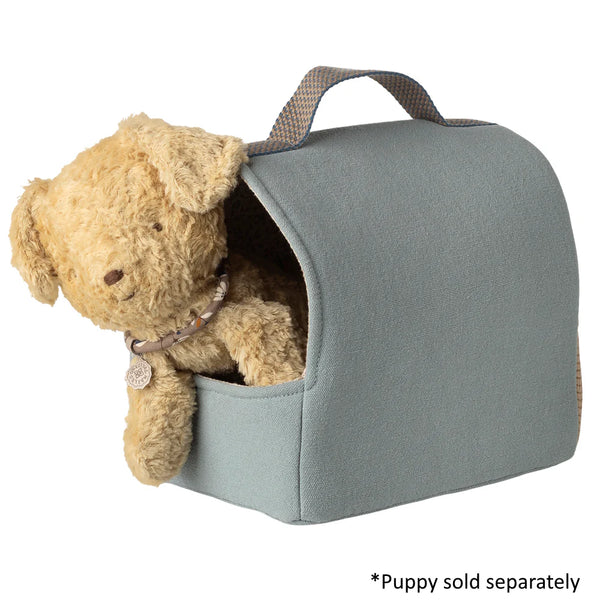 Gray pet carrier with a teddy bear inside on a white background
