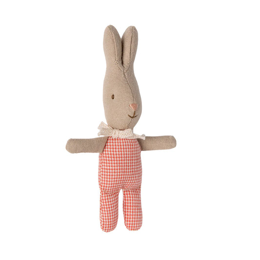 Stuffed toy rabbit in a red checkered outfit on a white background