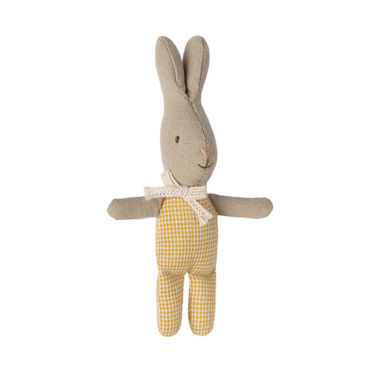 Stuffed toy rabbit with a yellow checkered outfit on a white background