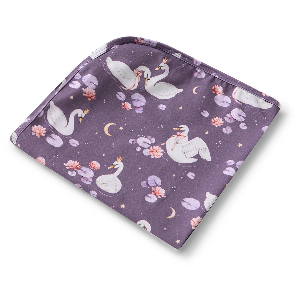 Folded purple fabric with swan pattern on a white background