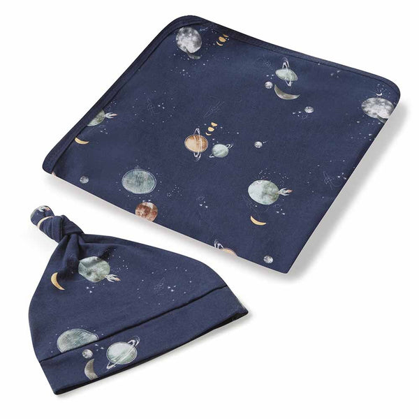 Navy blue baby blanket and hat set with space-themed design on a white background