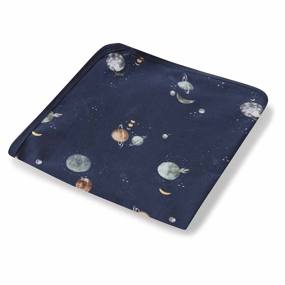Navy blanket with space-themed pattern featuring planets and stars on a white background