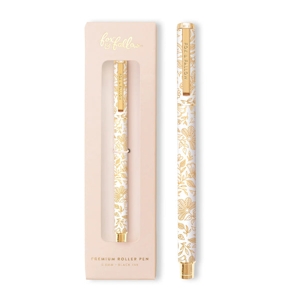 Gold and white floral-patterned pen with matching packaging on a white background